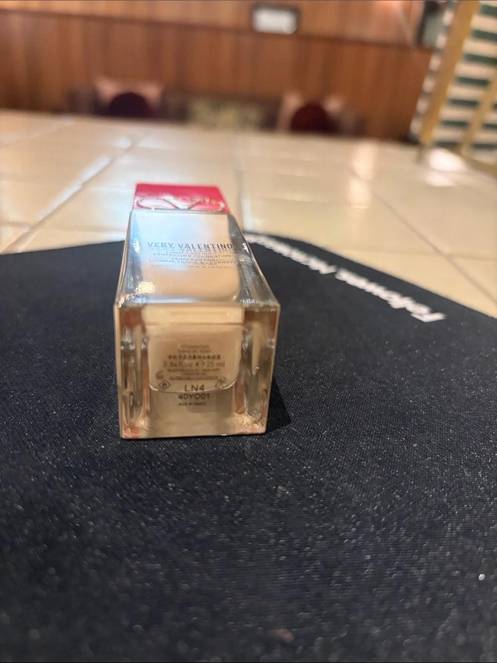 Valentino foundation bottle with red cap and beige serum LN4